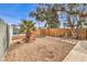 Large backyard with stone pathway, palm tree, and wooden fence at 108 S Mallard St, Las Vegas, NV 89107