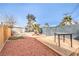 Backyard with wooden deck, artificial turf, and a palm tree at 108 S Mallard St, Las Vegas, NV 89107