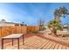 Backyard with wooden deck, gravel landscaping, and wooden fence at 108 S Mallard St, Las Vegas, NV 89107