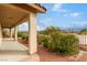 Covered back porch area overlooking the backyard with desert landscaping and greenery at 1172 Via Della Costrella, Henderson, NV 89011