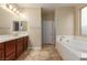 Bathroom with double vanity, soaking tub and tile flooring at 1172 Via Della Costrella, Henderson, NV 89011