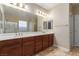 Bathroom featuring double sink vanity, large mirror, and shower at 1172 Via Della Costrella, Henderson, NV 89011