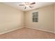 Bedroom featuring neutral paint and carpet flooring, with ceiling fan and window at 1172 Via Della Costrella, Henderson, NV 89011