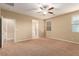 Large bedroom with carpet, ceiling fan and access to bathroom at 1172 Via Della Costrella, Henderson, NV 89011