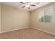 Bedroom featuring neutral paint and carpet flooring, with ceiling fan and window at 1172 Via Della Costrella, Henderson, NV 89011