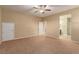 Bright bedroom with neutral carpet, ceiling fan and bathroom access at 1172 Via Della Costrella, Henderson, NV 89011