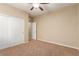 Bright bedroom with ceiling fan, carpet, and double door closet at 1172 Via Della Costrella, Henderson, NV 89011