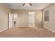 Comfortable bedroom featuring neutral walls, plush carpeting, and a ceiling fan at 1172 Via Della Costrella, Henderson, NV 89011