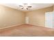 Neutral carpeted bedroom featuring a ceiling fan and ample natural light at 1172 Via Della Costrella, Henderson, NV 89011