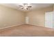 Comfortable bedroom featuring neutral walls, plush carpeting, and a ceiling fan at 1172 Via Della Costrella, Henderson, NV 89011