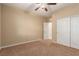 Bedroom featuring neutral paint and carpet flooring, with ceiling fan, closet, and base trim at 1172 Via Della Costrella, Henderson, NV 89011