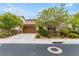 House exterior with a brown garage door and mature landscaping at 1172 Via Della Costrella, Henderson, NV 89011