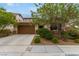 One-story house with brown garage door, landscaping, and a tree at 1172 Via Della Costrella, Henderson, NV 89011