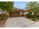 House exterior featuring a brown garage door and landscaping at 1172 Via Della Costrella, Henderson, NV 89011