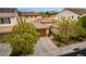 Tan two-story house with a brown garage door and landscaping at 1172 Via Della Costrella, Henderson, NV 89011