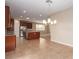 Open-concept kitchen and dining area with stainless steel appliances and a kitchen island at 1172 Via Della Costrella, Henderson, NV 89011