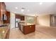 Spacious kitchen island with granite countertops, stainless steel appliances, and dark wood cabinets at 1172 Via Della Costrella, Henderson, NV 89011