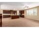 Open concept kitchen with dark wood cabinets and a large island at 1172 Via Della Costrella, Henderson, NV 89011