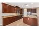 A stylish kitchen featuring granite countertops, stainless steel appliances, and a functional kitchen island at 1172 Via Della Costrella, Henderson, NV 89011