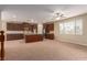 Kitchen with dark wood cabinets, island, and carpeted floor at 1172 Via Della Costrella, Henderson, NV 89011