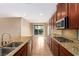 Modern kitchen featuring granite countertops and stainless steel appliances with outdoor access at 1172 Via Della Costrella, Henderson, NV 89011