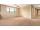 Carpeted living room with a large window offering natural light and neutral wall colors for versatile decorating at 1172 Via Della Costrella, Henderson, NV 89011