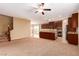 Bright, open-concept space with stairs, adjacent to the kitchen featuring dark wood cabinets and granite countertops at 1172 Via Della Costrella, Henderson, NV 89011