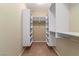 Walk-in closet with custom shelving, storage and carpet flooring at 1172 Via Della Costrella, Henderson, NV 89011