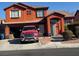 Two-story house with a red exterior and a red truck parked in the driveway at 1754 Green Apple Way, Las Vegas, NV 89142