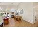 Open dining area with a wood table and chairs, and a view of the kitchen and fireplace at 1812 Dalton Dr, Henderson, NV 89014