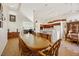 Bright dining room with an oval wood table and access to kitchen and living room at 1812 Dalton Dr, Henderson, NV 89014