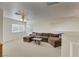 Spacious living room featuring a large sectional sofa and a coffee table at 1812 Dalton Dr, Henderson, NV 89014