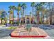 Gated community entrance with palm trees and signage at 1830 N Buffalo Dr # 1007, Las Vegas, NV 89128