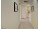 Simple hallway with light walls and tile floors at 1830 N Buffalo Dr # 1007, Las Vegas, NV 89128