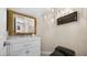 Nicely decorated powder room featuring a white vanity, ornate mirror and black toilet at 2107 Inverness Dr, Henderson, NV 89074