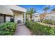 Landscaped front yard with a brick pathway and lush greenery at 2107 Inverness Dr, Henderson, NV 89074