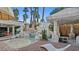 Resort-style pool with rock features, palm trees, and a covered outdoor kitchen at 2107 Inverness Dr, Henderson, NV 89074