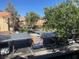 View of apartment building and parking lot with covered spaces at 2120 Ramrod Ave # 1721, Henderson, NV 89014