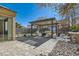 Inviting backyard with a pergola covered dining area, stone patio, and landscaped yard at 217 Via Luna Rosa Ct, Henderson, NV 89011