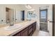 A spacious bathroom with double sink vanity, large mirror, and tile floors at 217 Via Luna Rosa Ct, Henderson, NV 89011