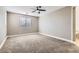 This is a bedroom featuring neutral walls, large windows, ceiling fan, and neutral carpet at 217 Via Luna Rosa Ct, Henderson, NV 89011