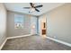 This is a bedroom featuring neutral walls, large windows, ceiling fan, and neutral carpet at 217 Via Luna Rosa Ct, Henderson, NV 89011