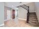 Inviting foyer with stairs, tile flooring, neutral walls, and a decorative front door at 217 Via Luna Rosa Ct, Henderson, NV 89011