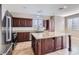 Open concept kitchen featuring granite countertops, stainless steel appliances, and a large island at 217 Via Luna Rosa Ct, Henderson, NV 89011