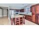 Kitchen with stainless steel appliances, granite countertops, dark wood cabinetry, and a center island perfect for entertaining at 217 Via Luna Rosa Ct, Henderson, NV 89011