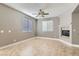 Living space open with tile flooring, neutral walls, bright windows, and a fireplace for gathering at 217 Via Luna Rosa Ct, Henderson, NV 89011