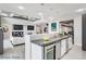 Modern kitchen island with built-in wine cooler and breakfast bar at 2272 Horizon Light Ct, Henderson, NV 89052