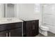 Clean bathroom with dark vanity, toilet and shower/tub combo at 2364 Boretto St, Henderson, NV 89044