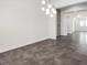 Open dining room area with dark brown tile floor and stone accent wall at 2364 Boretto St, Henderson, NV 89044