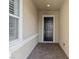 Front entry with dark-stained door, tile flooring, and a window at 2364 Boretto St, Henderson, NV 89044